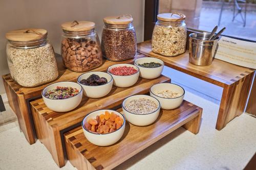 a group of bowls of food on a wooden table at Appart Hotel Odalys City Aix en Provence L'Atrium in Aix-en-Provence