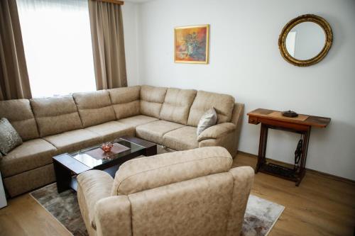 a living room with a couch and a table at Adi apartment in town centar in Konjic