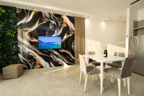 a dining room with a white table and chairs at Rezidenca Panorama Apartments in Vlorë