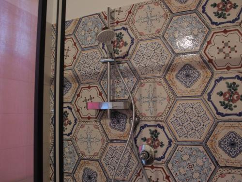 a shower in a bathroom with a tile wall at Le Dame Country House, Marche in Montegranaro