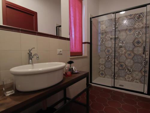 a bathroom with a sink and a shower at Le Dame Country House, Marche in Montegranaro