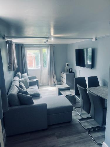 a living room with a couch and a table at Modern Oxford Retreat - Free parking in Oxford