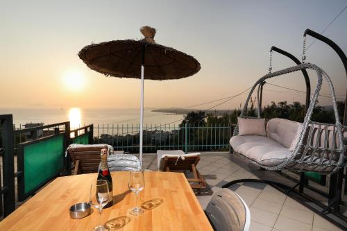 a table with a bottle of wine on top of a balcony at Rezidenca Panorama Apartments in Vlorë