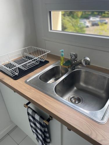 un évier de cuisine avec un égouttoir à vaisselle à côté dans l'établissement PARIS Arena la Défense, à Rueil-Malmaison