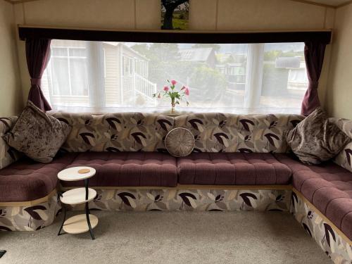 a couch in a living room with a window at Sylvan in Builth Wells