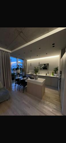 a living room with a kitchen and a dining room at Arcadia in Odesa