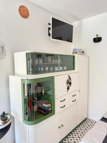 a large white cabinet with a tv on a wall at Garsonka v srdci Vysočiny in Žďár nad Sázavou