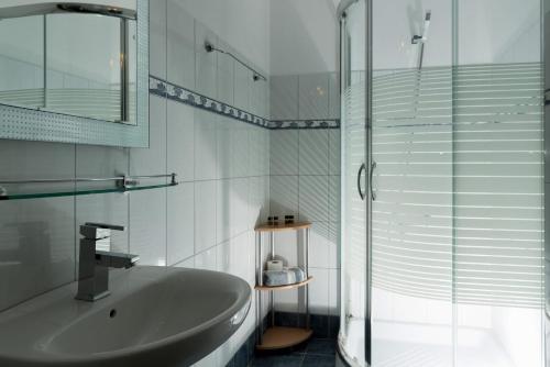 a bathroom with a sink and a glass shower at Eirini luxury Apartments in Keramoti