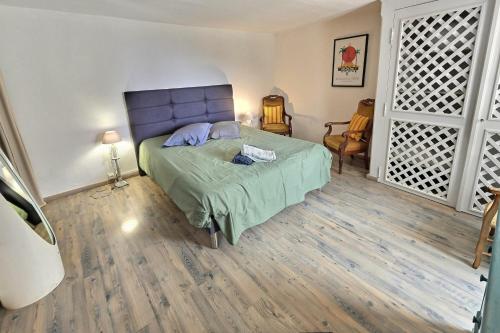 une chambre avec un lit avec une tête de lit bleue dans l'établissement Les Bulles de Montfort - WiFi - Parking gratuit & Cuisine, à Montfort