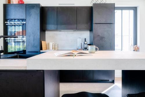 a kitchen with a counter with a book on it at Beautiful 3-Bedroom Home with Garden & Parking in Deinze