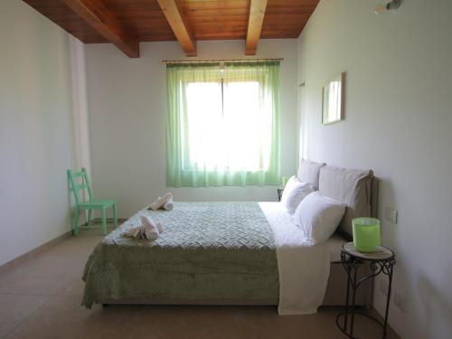 a bedroom with a bed and a window at Le Dame Country House, Marche in Montegranaro