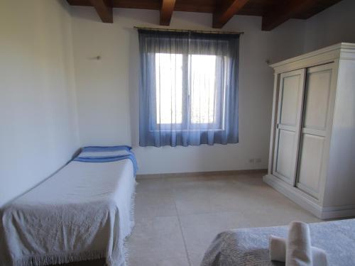 a bedroom with two beds and a window at Le Dame Country House, Marche in Montegranaro