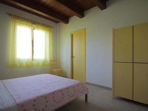 a bedroom with a bed and a dresser and a window at Le Dame Country House, Marche in Montegranaro