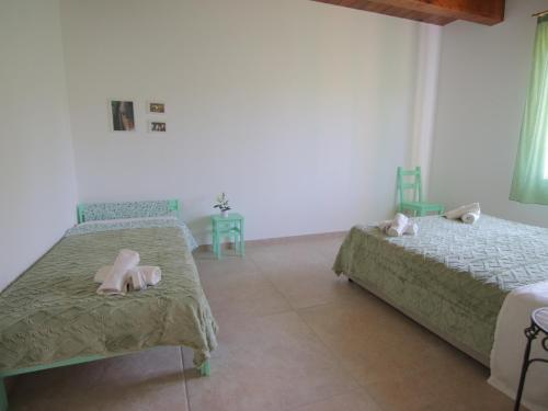 a bedroom with two beds with dolls on them at Le Dame Country House, Marche in Montegranaro