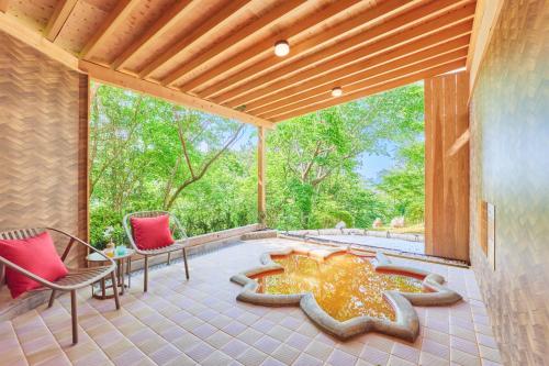 an outdoor patio with chairs and a fire pit at Arima Onsen Motoyu Ryuusenkaku in Kobe