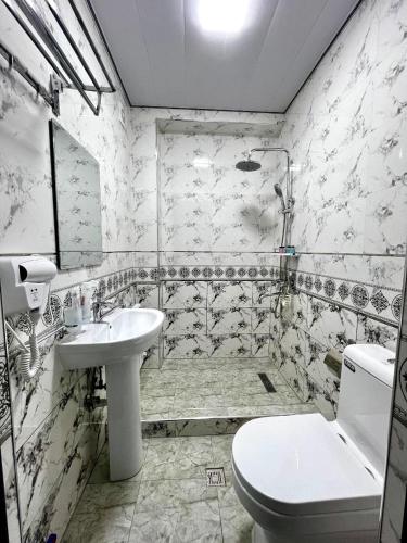 a bathroom with a toilet and a sink at RUDAKIY Hotel in Samarkand