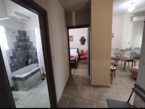 a bathroom with a tub and a room with a dining room at Kavala Summer in Kavála