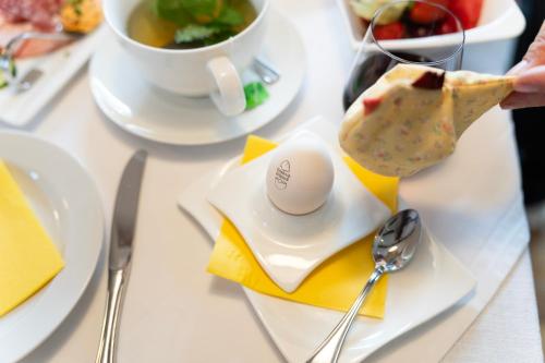 a table with plates of food and a egg on it at Erlebnishaus Spiess in Feldkirchen in Kärnten