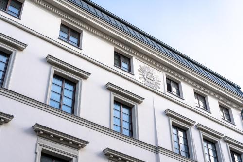 a facade of a white building with windows at Hotel Experior Boutique - Destigo Hotels in Kraków