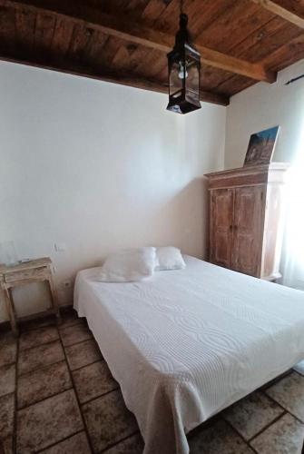 une chambre avec un lit blanc dans une pièce dans l'établissement Lei bugadiero, à La Croix-Valmer