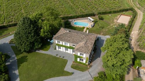 an aerial view of a house with a swimming pool at Villa Saint-Lager - Séjour de charme au cœur du Beaujolais in Saint-Lager