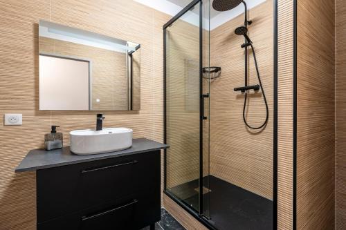 une salle de bain avec un lavabo et une douche dans l'établissement Pietra Di Mare - Au coeur d'Ajaccio, à Ajaccio
