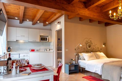 a kitchen and a bedroom with a bed in a room at Il Laghello Wood House in Framura
