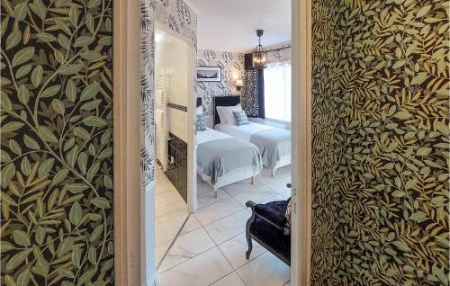 a hallway leading to a bedroom with a bed at Beautiful Home In Thierville With Wifi in Thierville