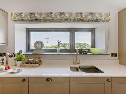 a kitchen with a sink and a window at 3 Bed in Hartland 91183 in Hartland