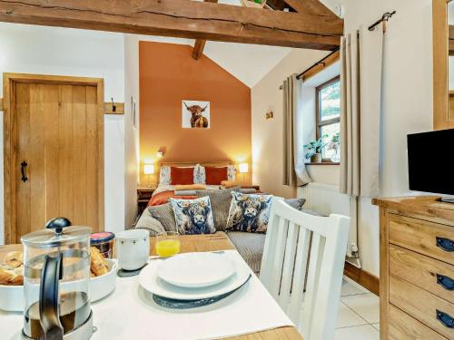 a dining room with a table and a living room at 1 Bed in Garth BN216 in Garth