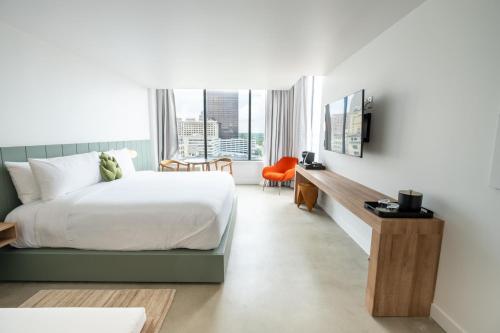 a hotel room with a bed and a desk at Dayton Vitality Hotel - Downtown in Dayton