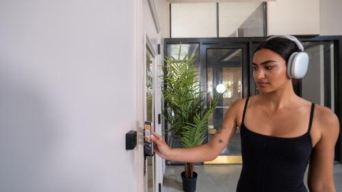 a woman wearing headphones and holding a cell phone at Dayton Vitality Hotel - Downtown in Dayton
