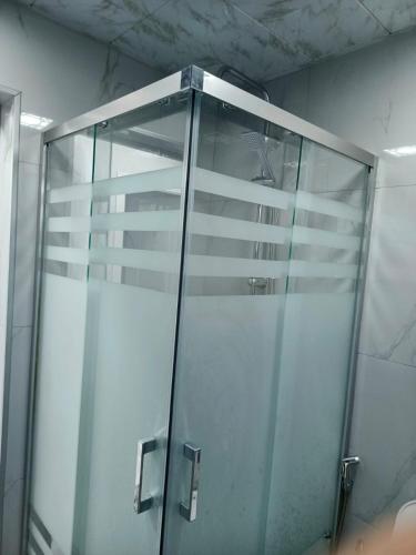 a shower stall with a glass door in a bathroom at The Mountain A-Frame Qusar in Yuxarı Lǝgǝr