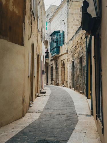 an empty street in an alley between buildings at 2BR Penthouse with Huge Terrace in peaceful Gozo by 360 Estates in Sannat