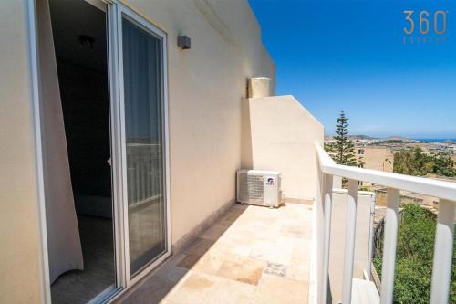 a balcony with a view of the ocean at 2BR Penthouse with Huge Terrace in peaceful Gozo by 360 Estates in Sannat
