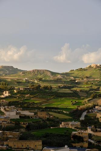 a view of a city with mountains in the background at 2BR Penthouse with Huge Terrace in peaceful Gozo by 360 Estates in Sannat