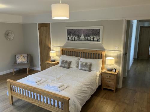 a bedroom with a bed with towels on it at Barn Cottage, Minehead in Minehead