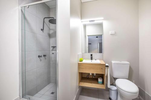 a bathroom with a shower and a toilet and a sink at Nightcap at Springwood Hotel in Springwood