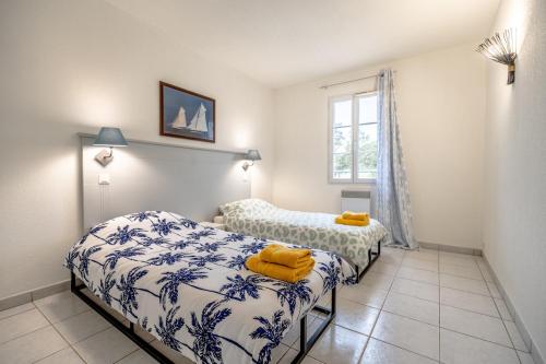 普朗德拉图尔Superbe Appartement climatisé dans résidence avec Piscine et parking的有两张床和一扇窗户的卧室