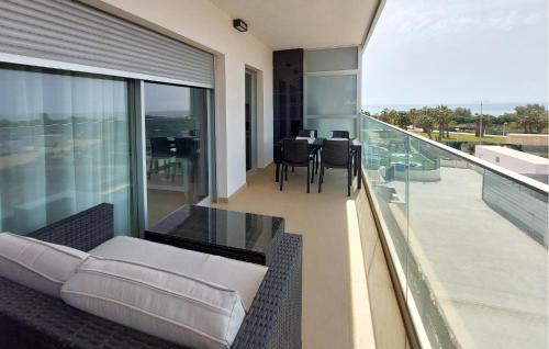a balcony with a couch and a table and chairs at Awesome Apartment In Cabanes in Cabanes