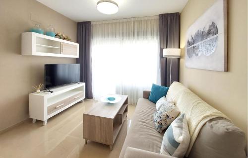 a living room with a couch and a tv at Awesome Apartment In Cabanes in Cabanes