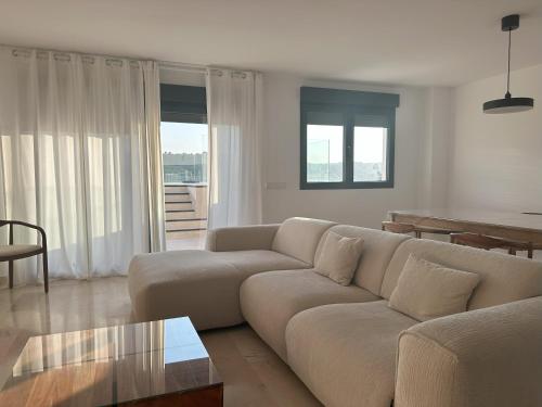 a living room with a couch and a table at Bellver Home Apartamentos in Chella