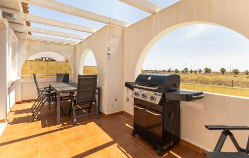 a kitchen with a stove and a table with chairs at Awesome Home In Avileses in Avileses