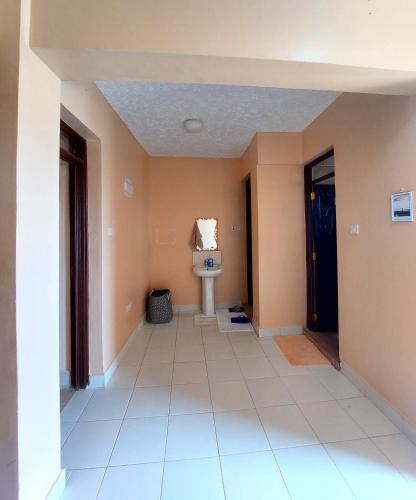 an empty hallway with a toilet in a room at Staycation with Karimi in Embu