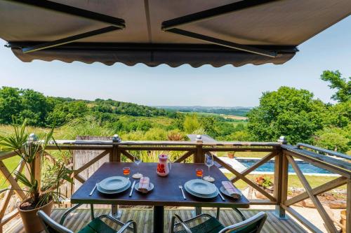 a table with plates of food on a balcony at L'Atelier de Scarlett 