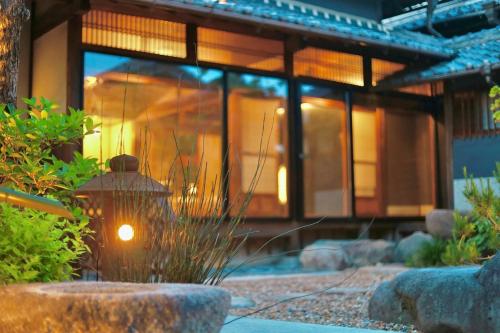 a house with a light in front of it at Osakaya Hotel & SAUNA in Kaizuka
