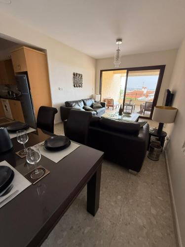 a living room with a couch and a table at Modern Comfort & Sea View - Aphrodite Gardens Pissouri in Pissouri