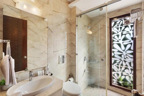 a bathroom with a sink and a shower at SaffronStays Barlowganj Villa in Mussoorie