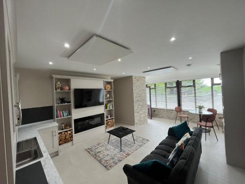 a living room with a couch and a table at Oakdale Lodge 