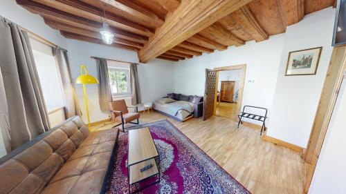 a living room with a couch and a table at Apartment in Historic Town House in Gmunden